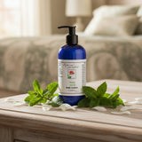 A cobalt blue pump bottle of Rebecca's Remedies 'Misty Fresh' body lotion, set against a plain white background.