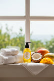 A bottle of Ocean Grass Body Oil with a black pump dispenser and a white oval label, filled with yellow oil, set against a plain white background.